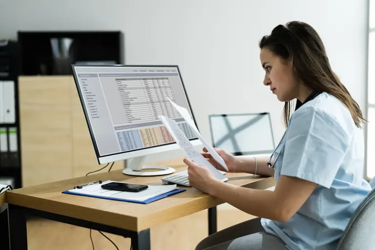 Medical billing specialist reviewing claim information